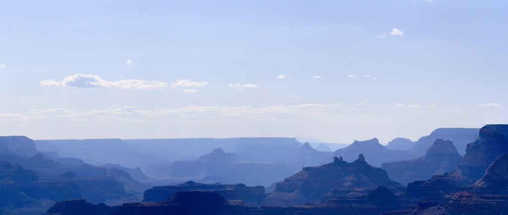 View across the Grand Canyon from Desert View, Smoke in the Canyon creates a "blue-ing" effect, casting the typical browns and reds in shades of blue, 